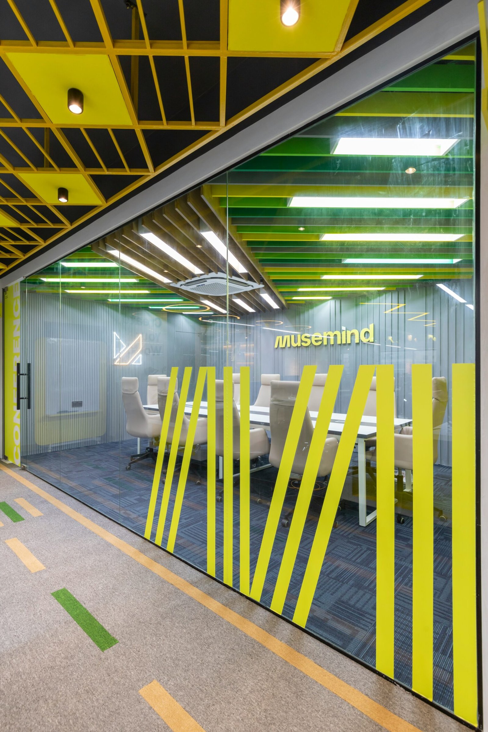 an office with yellow and black accents and a glass wall