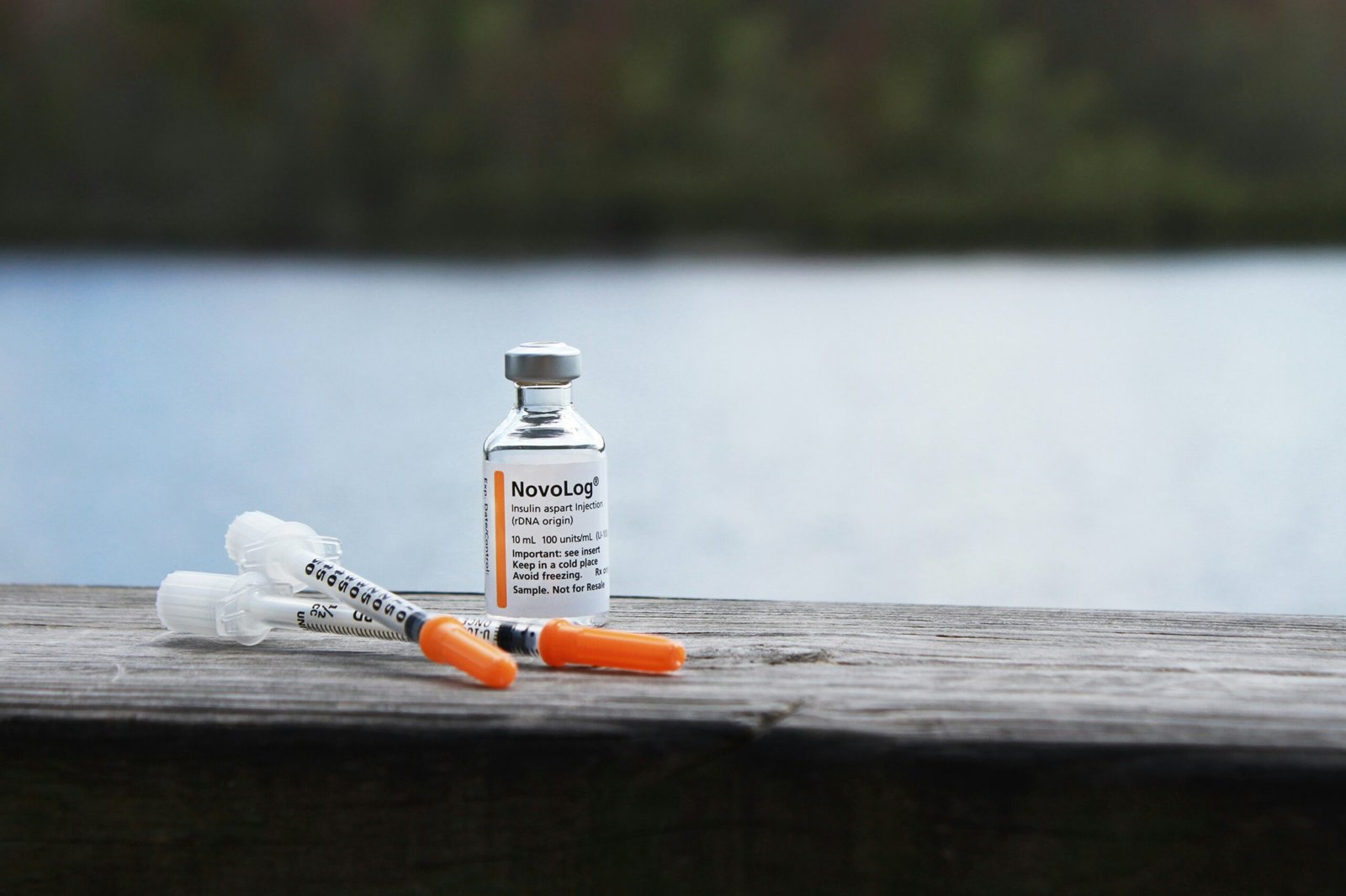 orange and white plastic bottle on brown wooden table